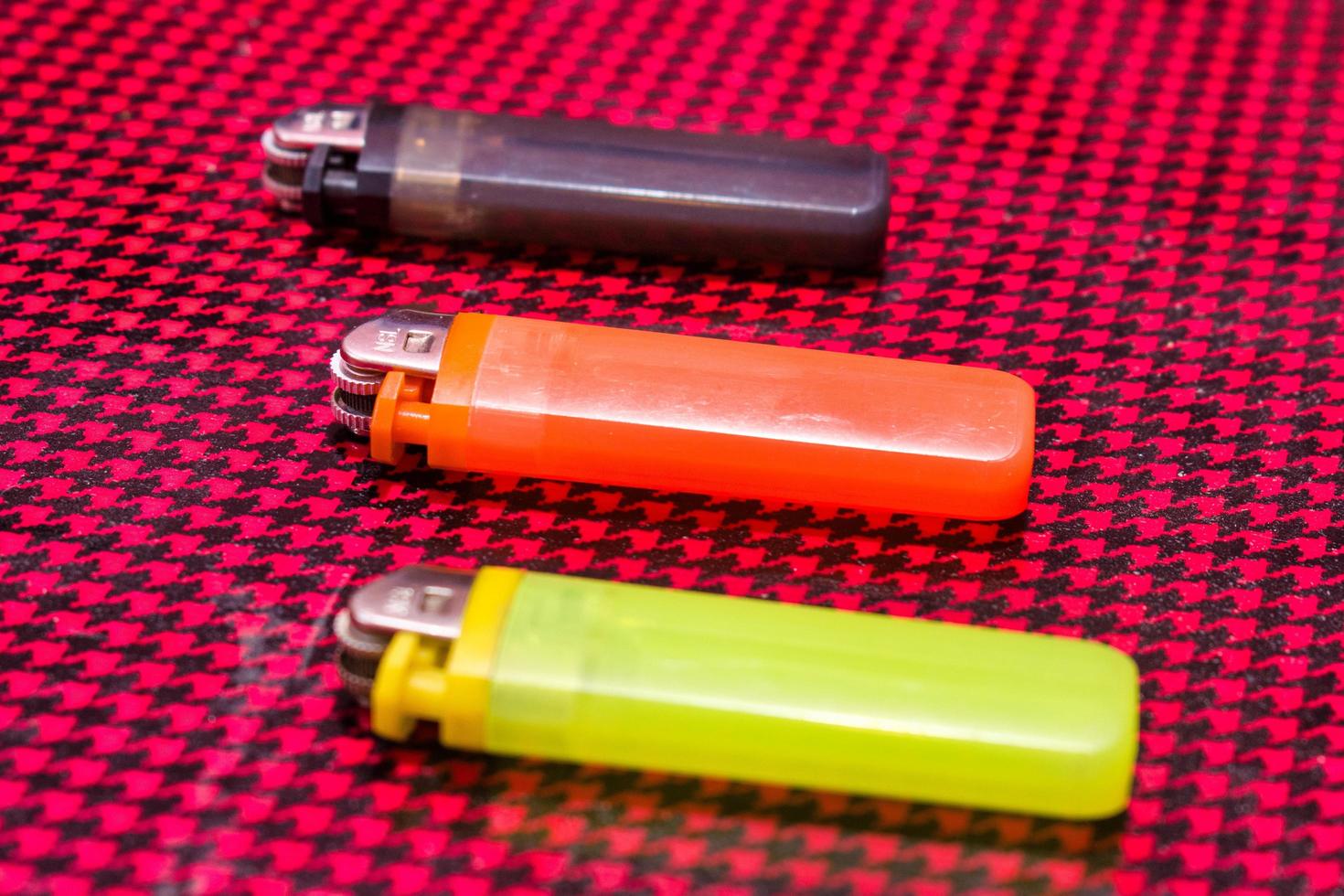 Colorful Plastic Gas Lighter on a textured background. photo