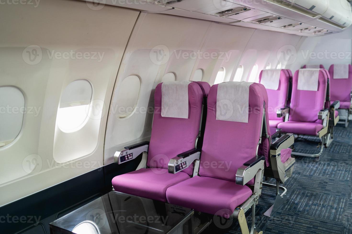 Passenger airplane seats in the cabin.Interior of commercial airplane on their seats during flight economy class passenger section of aircraft. photo