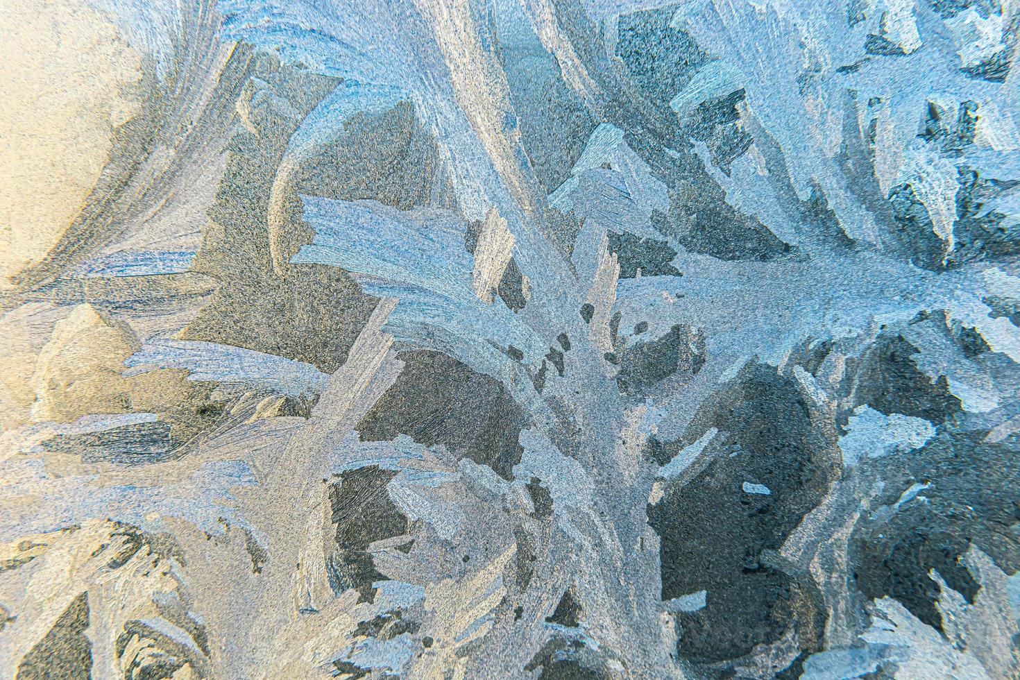 Frozen winter window with shiny ice frost pattern texture. Christmas wonder symbol, abstract background. Extreme north low temperature, natural Ice snow on frosty glass, cool winter weather outdoor. photo