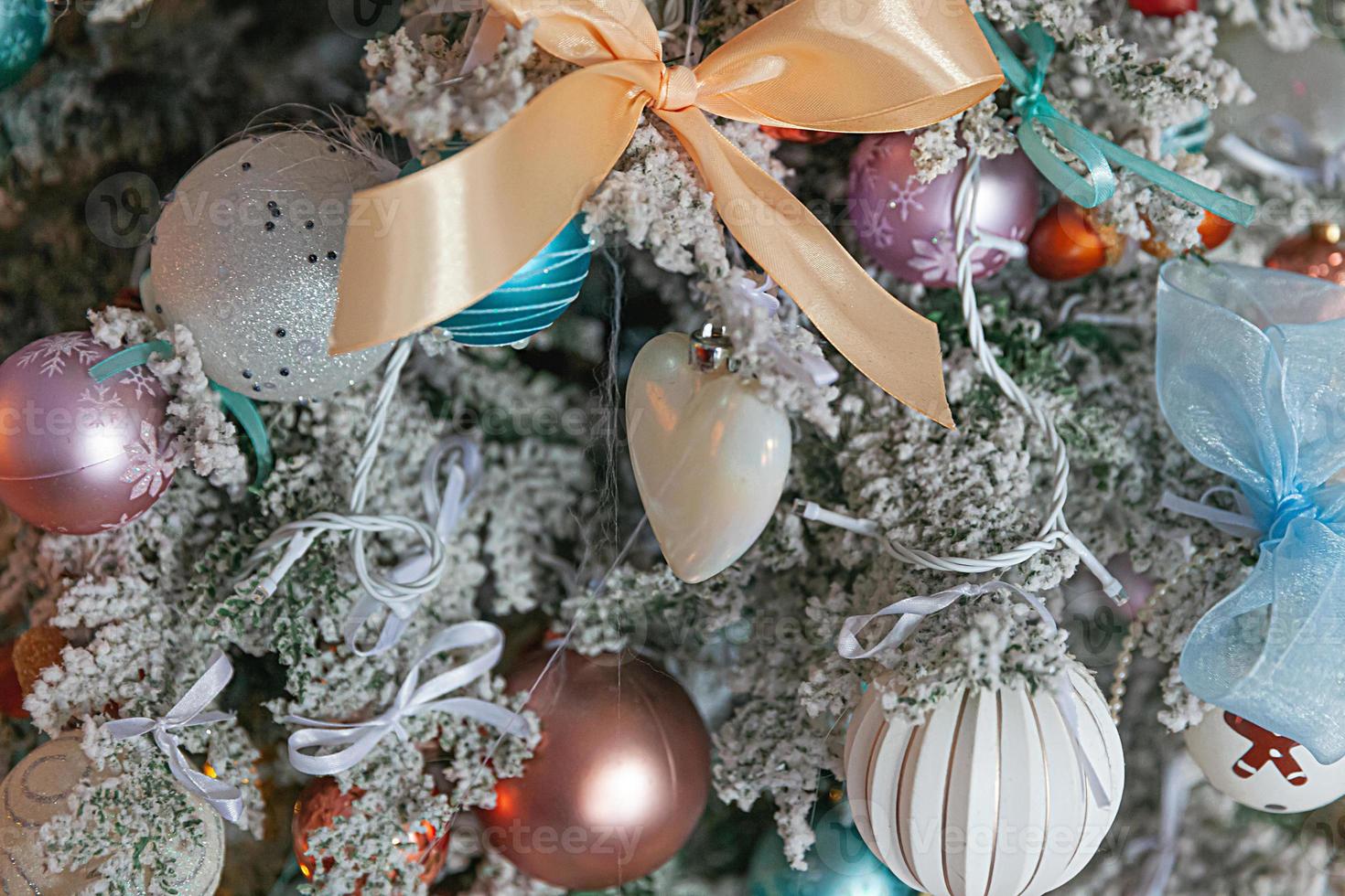 Classic Christmas New Year decorated New year tree with silver and white ornament decorations toy and ball. Modern classical style interior design apartment. Christmas eve at home. photo