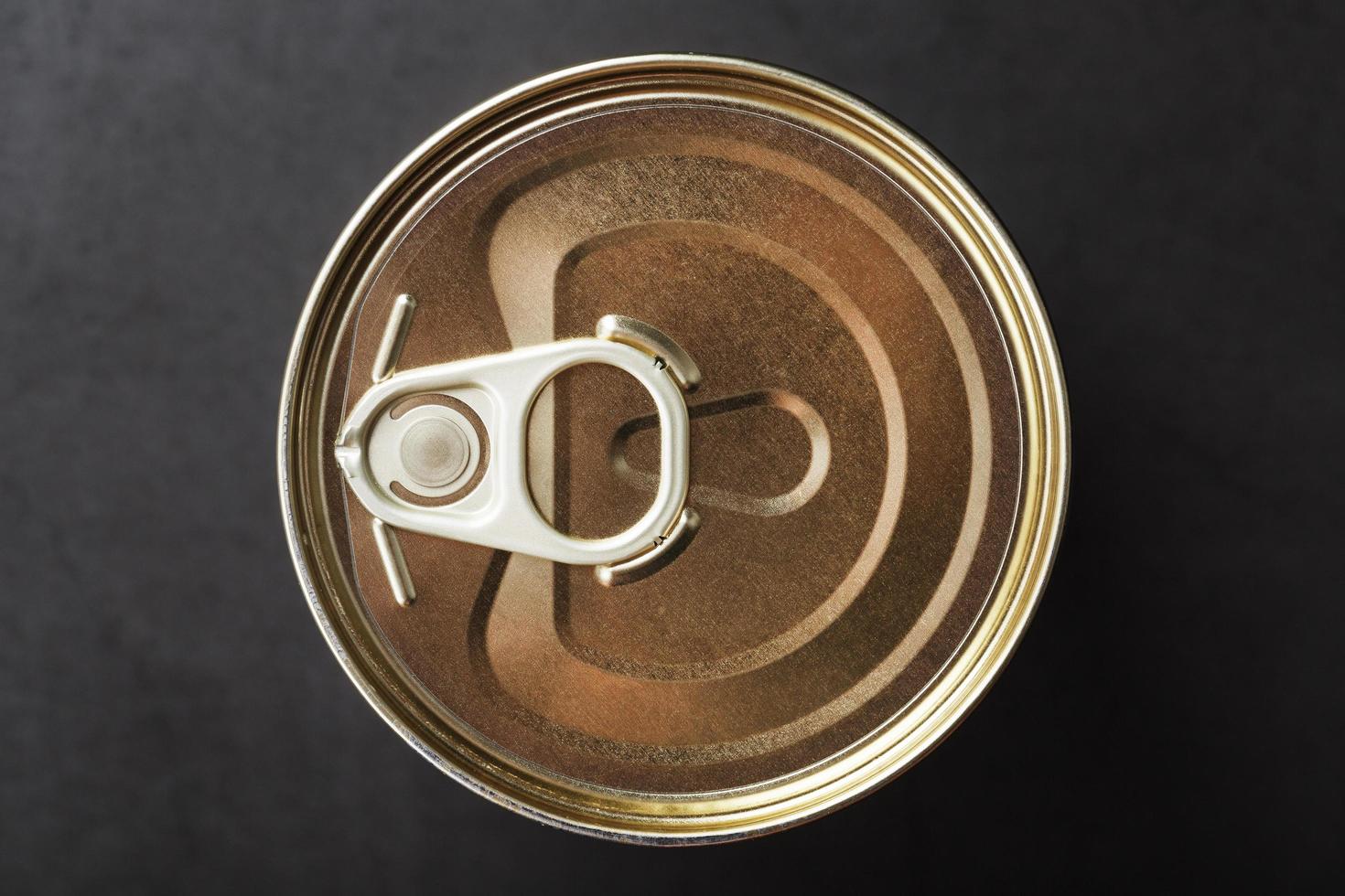 A can with a metal lid and a ring for opening photo