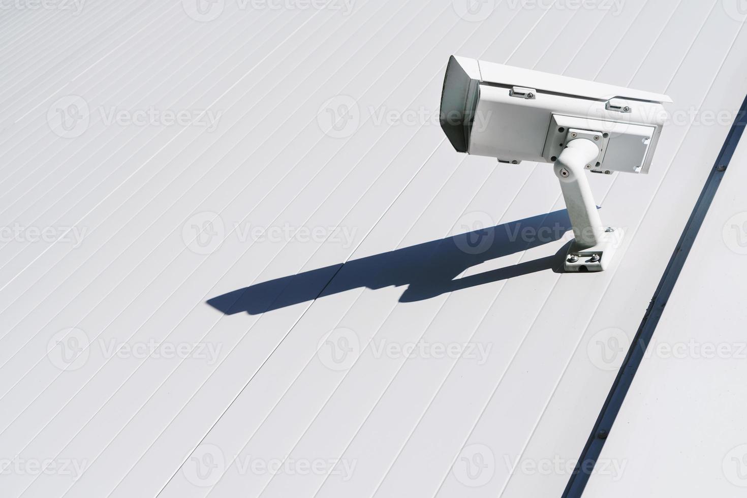 CCTV camera on the wall of the building for monitoring and protection. photo