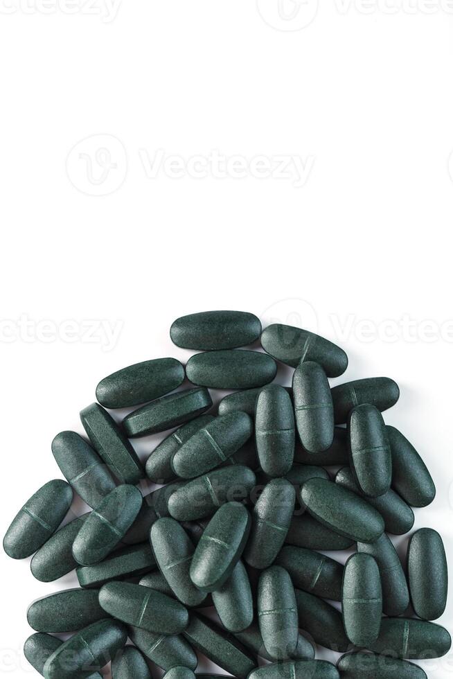 Green spirulina pills with multivitamins on a white background. 11070834 Stock Photo at Vecteezy