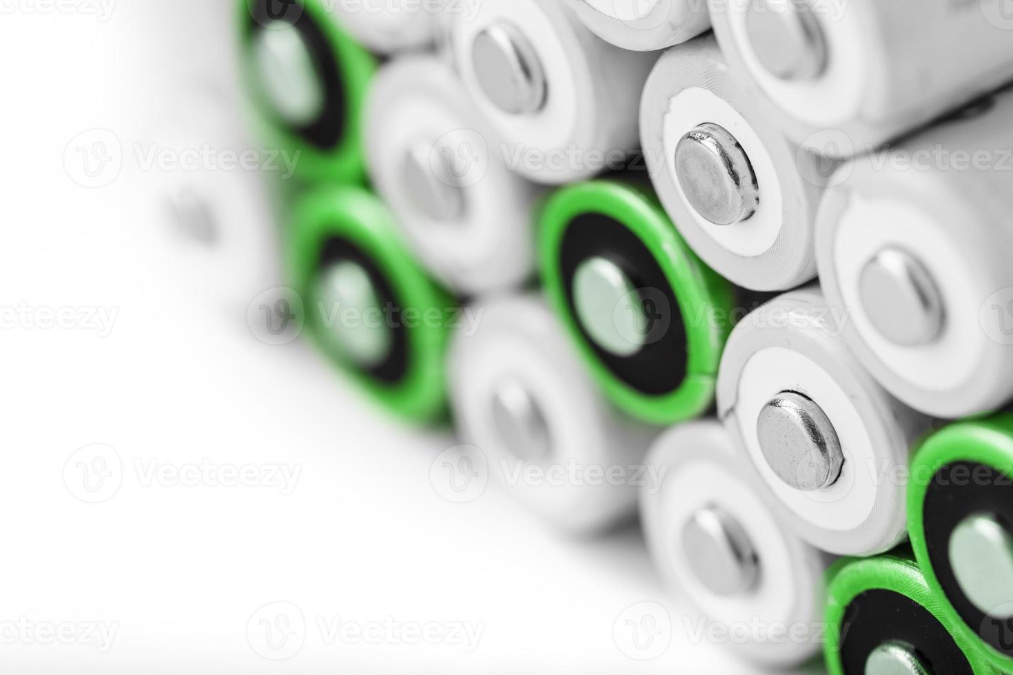 Pyramids of AA batteries on a white background with free space. photo