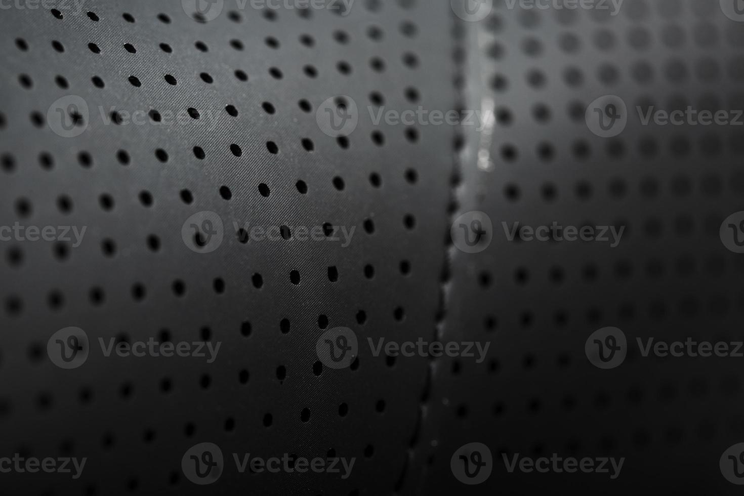 Close-up full-screen black textured leather with perforations photo