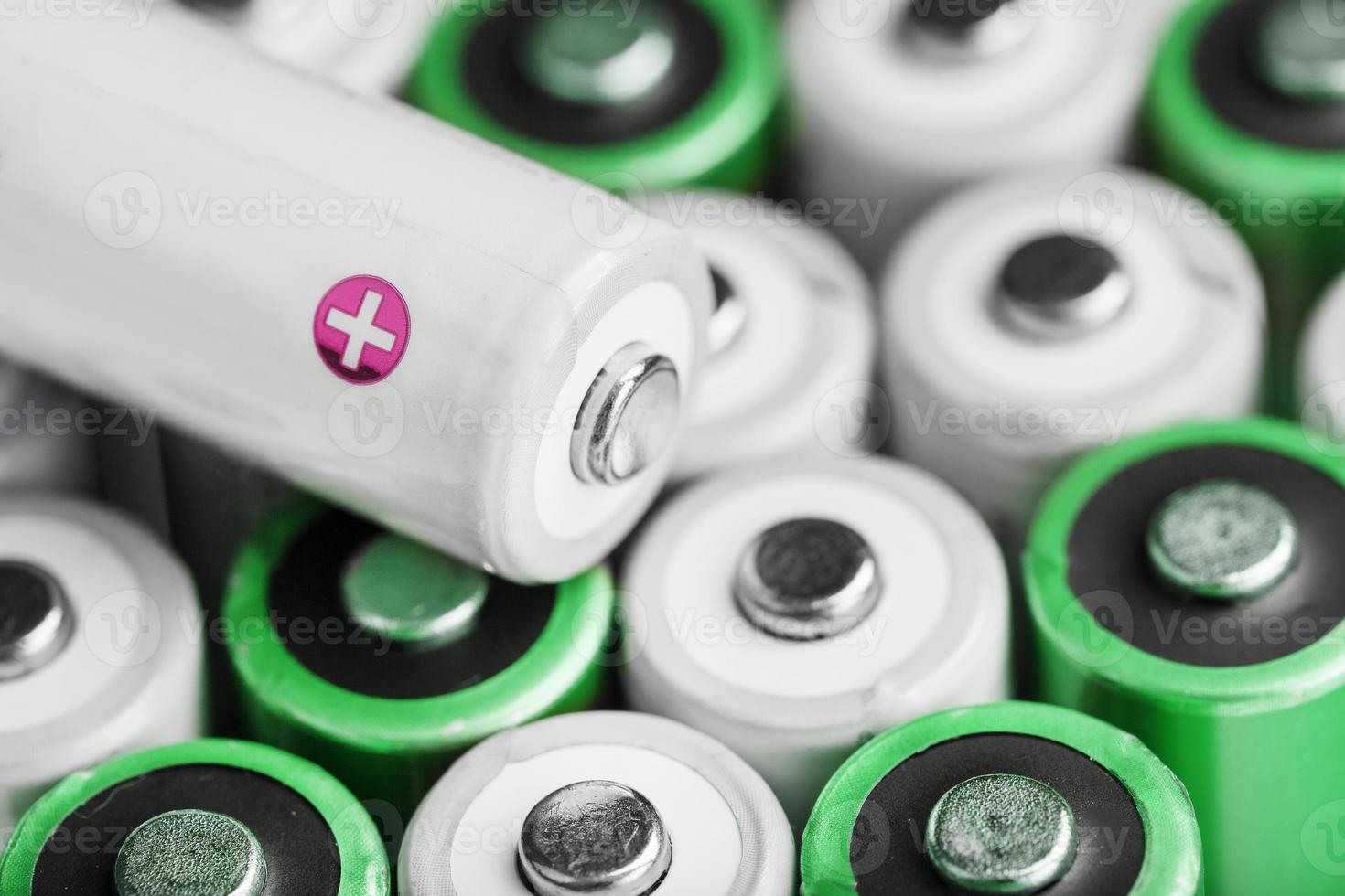 Rechargeable AA batteries with white and positive polarity. photo
