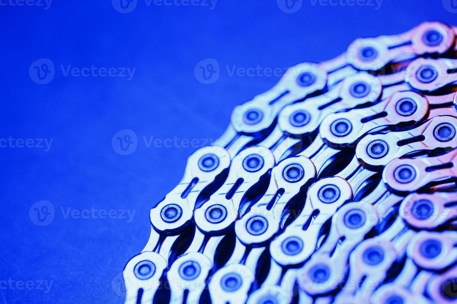 The texture of a Shiny bicycle chain with blue-purple backlight photo