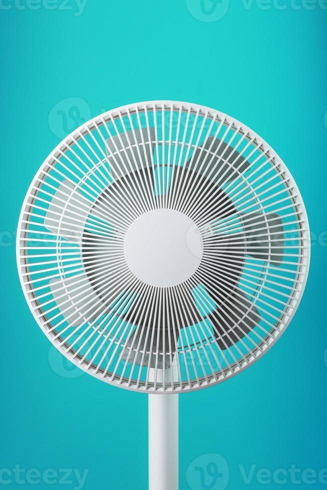 A high-tech white electric fan with a modern design for cooling the room on a blue background photo