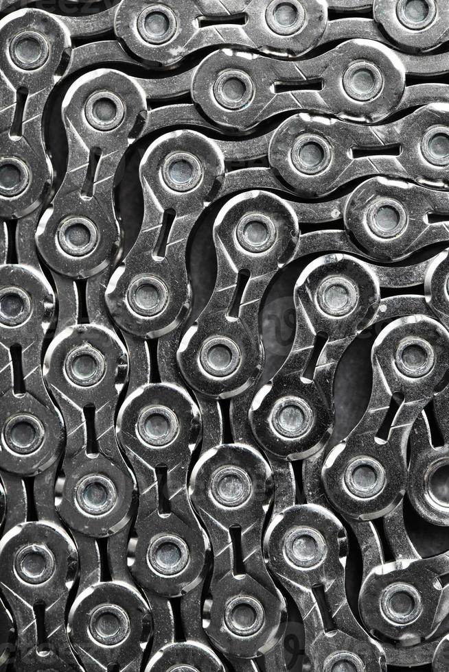 The texture of a bicycle chain is a close-up of the torque transmission links photo