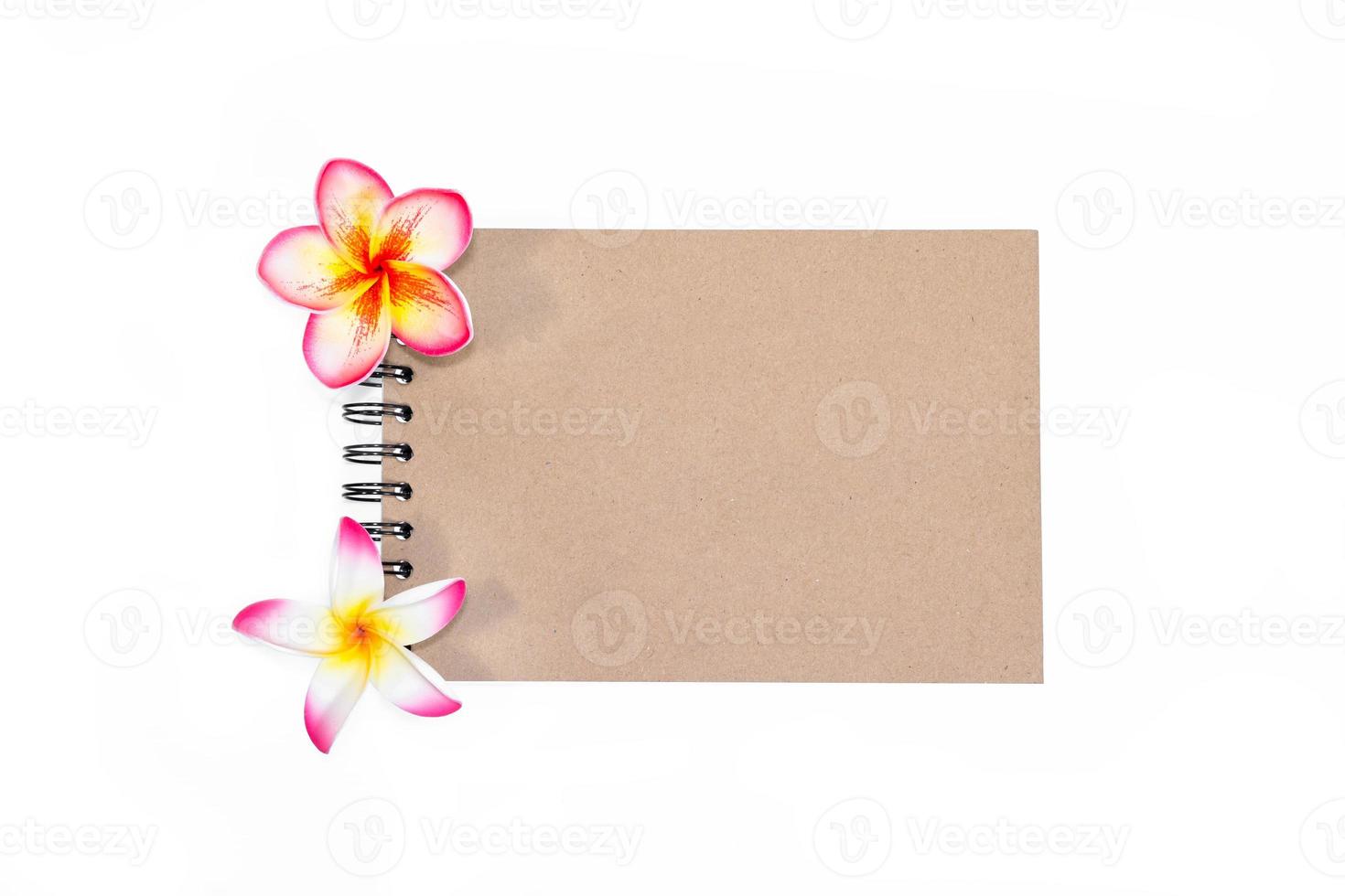 closeup close note book with plumeria on background photo