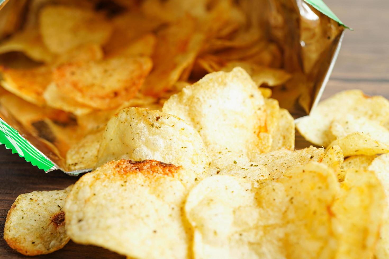 Potato chips in open bag, delicious BBQ seasoning spicy for crips, thin slice deep fried snack fast food in open bag. photo