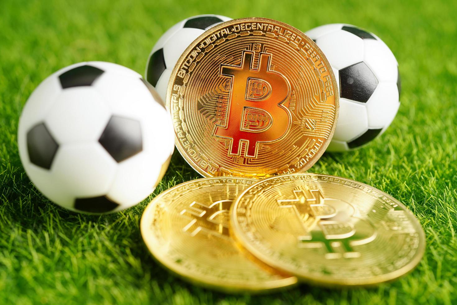 Gold bitcoin with soccer ball or football, cryptocurrency used in online sports betting. photo