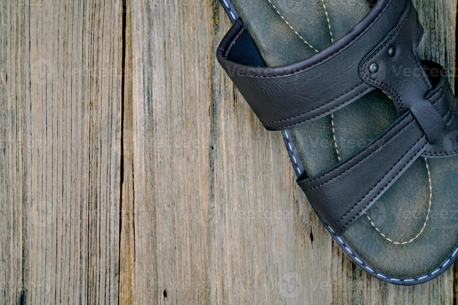 closeup brown leather slippers on wood background,top view photo