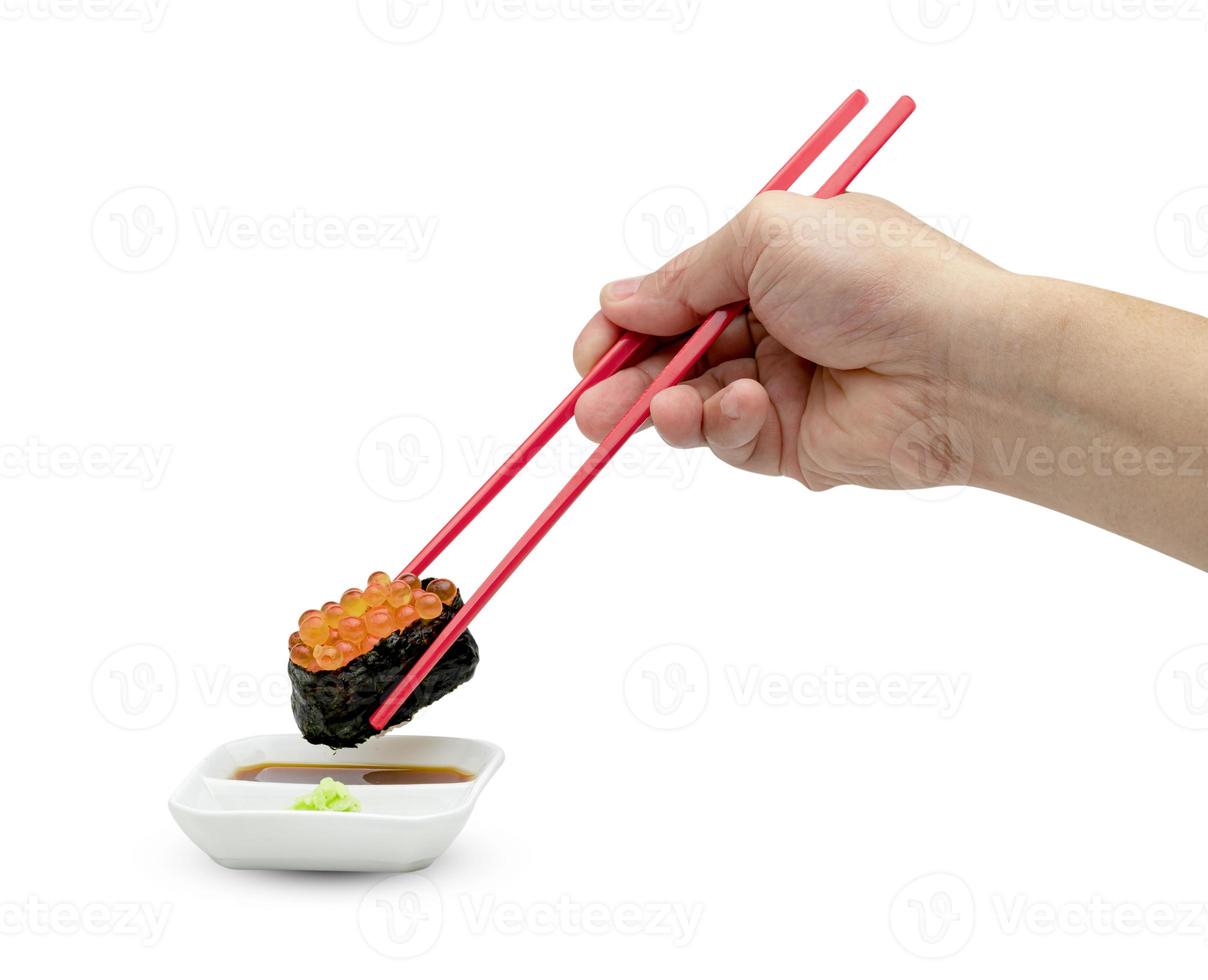rolled sushi of salmon roe nigiri with hand hold red chopsticks and japanese wasabi sauce isolated on white background ,include clipping path photo
