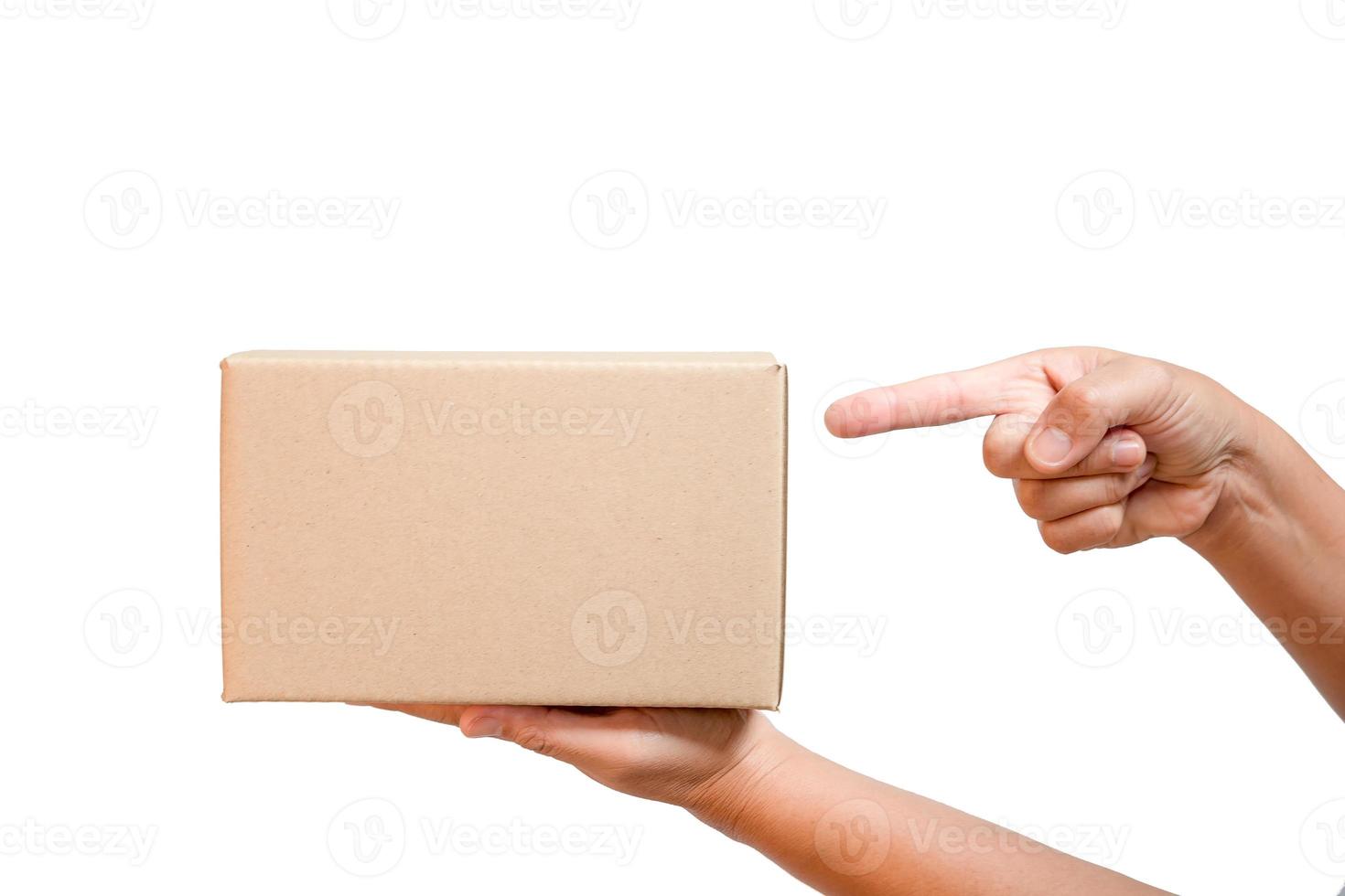 A parcel cardboard parcel box in a delivery woman person hands isolated on white background. Delivery service concept. Asian Young girl holding a package is a delivery business entrepreneur. photo