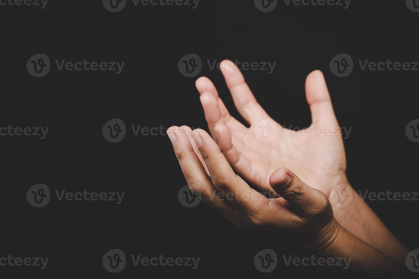 Close up Asian christian woman hands person pray and worship for thank god in church with black background, The concept for faith, spirituality and religion photo