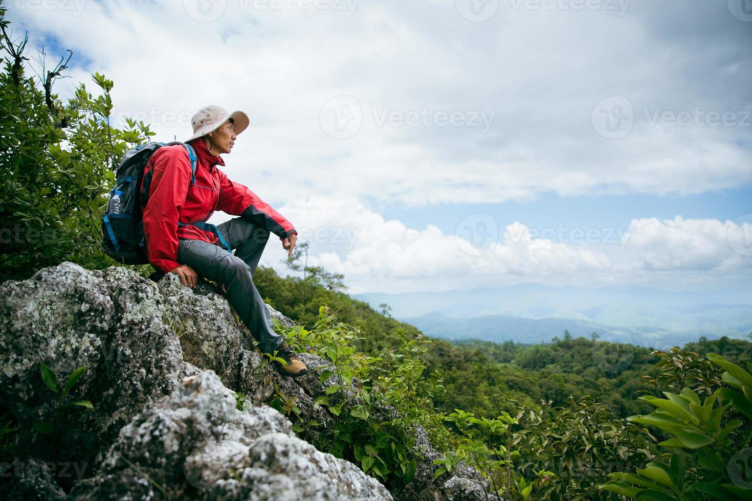 Young person hiking male on top rock, Backpack man looking at beautiful