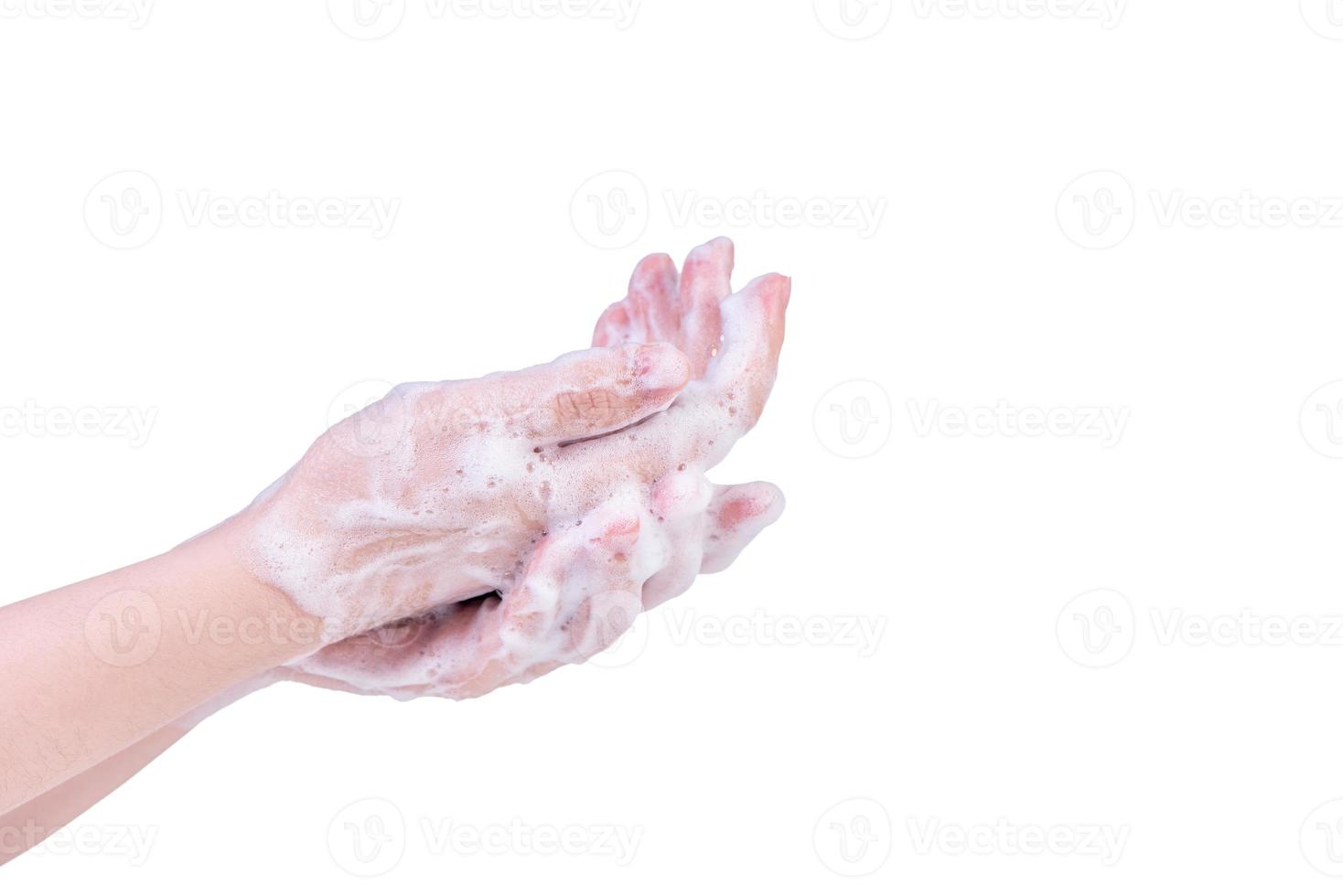 Washing hands isolated on white background. Asian young woman using liquid soap to wash hands, concept of protecting pandemic coronavirus, close up. photo