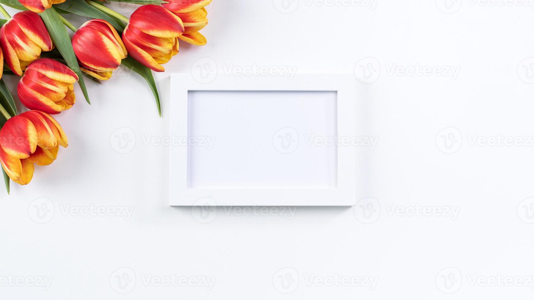 Mother's Day background, tulip flower bunch - Beautiful Red, yellow bouquet isolated on white table, top view, flat lay, mock up design concept. photo