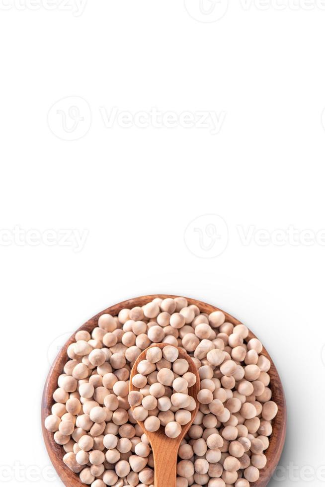 Dry raw brown tapioca pearls in a wooden bowl with spoon isolated on white background, close up, ingredient of making bubble boba milk tea. photo