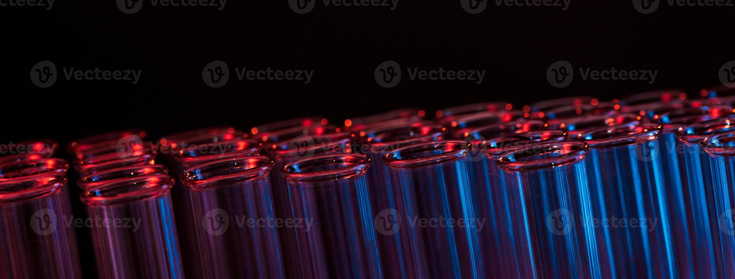 Test tube row. Concept of medical or science laboratory, liquid drop droplet with dropper in blue tone background, close up, micro photography picture. photo