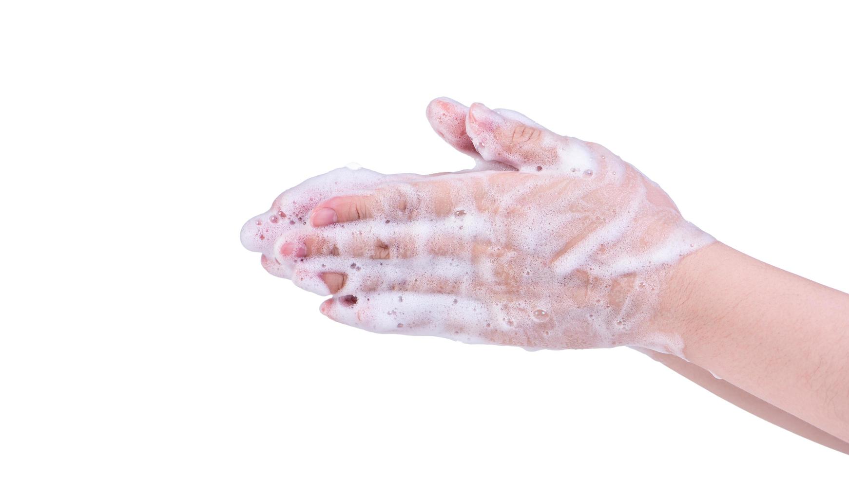 Washing hands isolated on white background. Asian young woman using liquid soap to wash hands, concept of protecting pandemic coronavirus, close up. photo