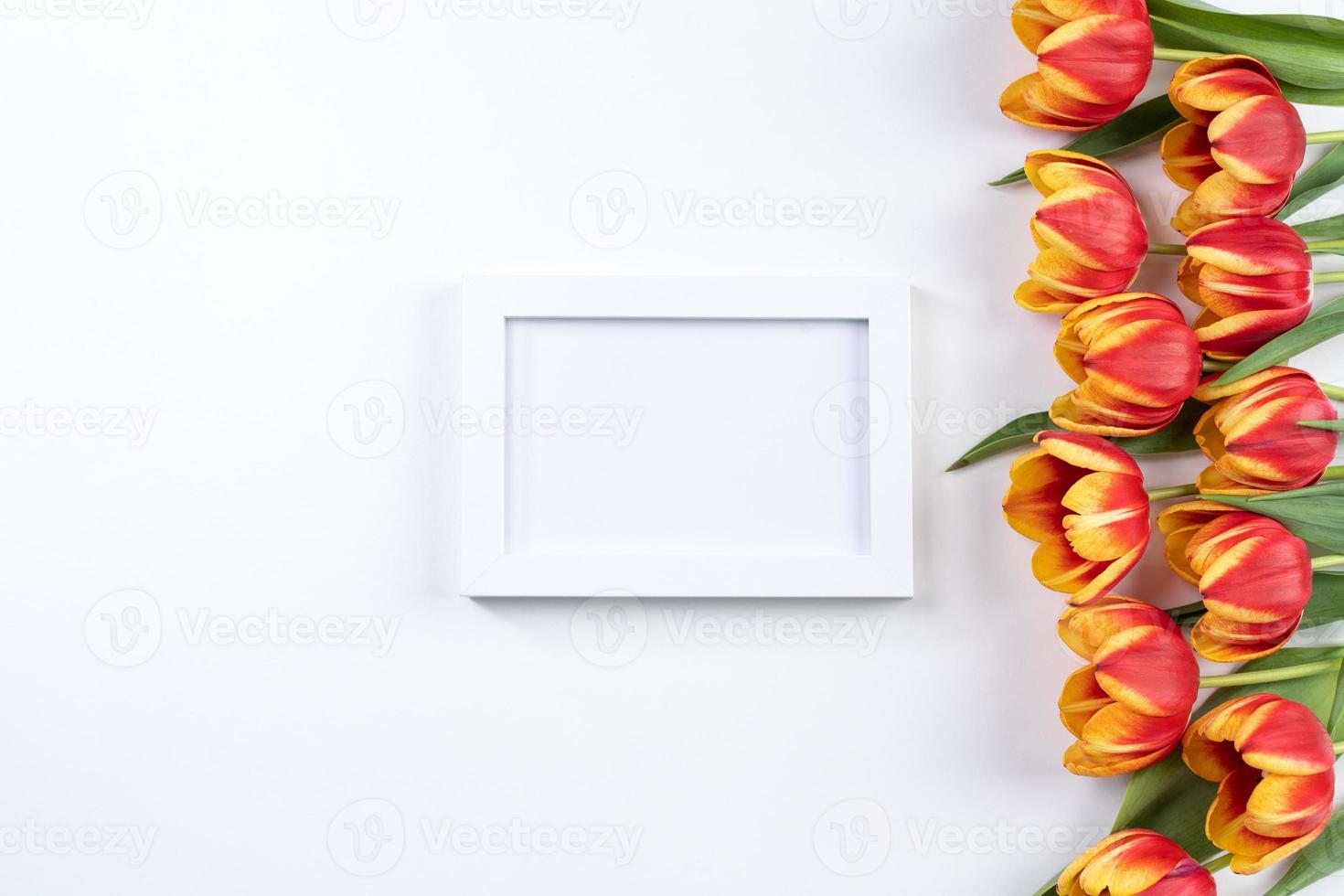 Mother's Day background, tulip flower bunch - Beautiful Red, yellow bouquet isolated on white table, top view, flat lay, mock up design concept. photo