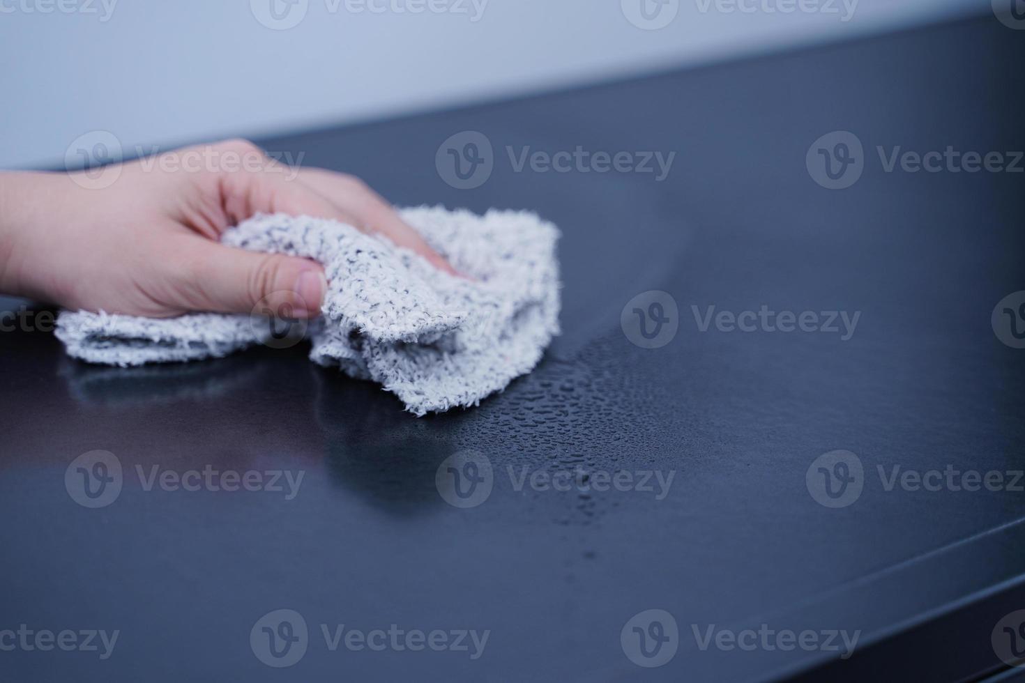 Young woman is holding spray bottle, rag to clean, wipe down office metal cabinet shelf accommodation surface, close up, lifestyle, concept of antibacterial. photo