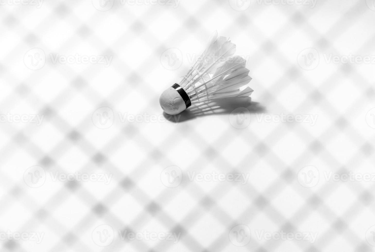 Shuttlecock and badminton racket shadow photo
