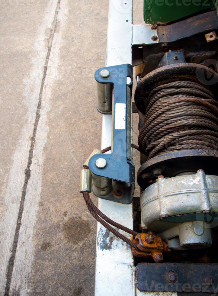 Old sling cable of electric winch in front of 4wd car photo
