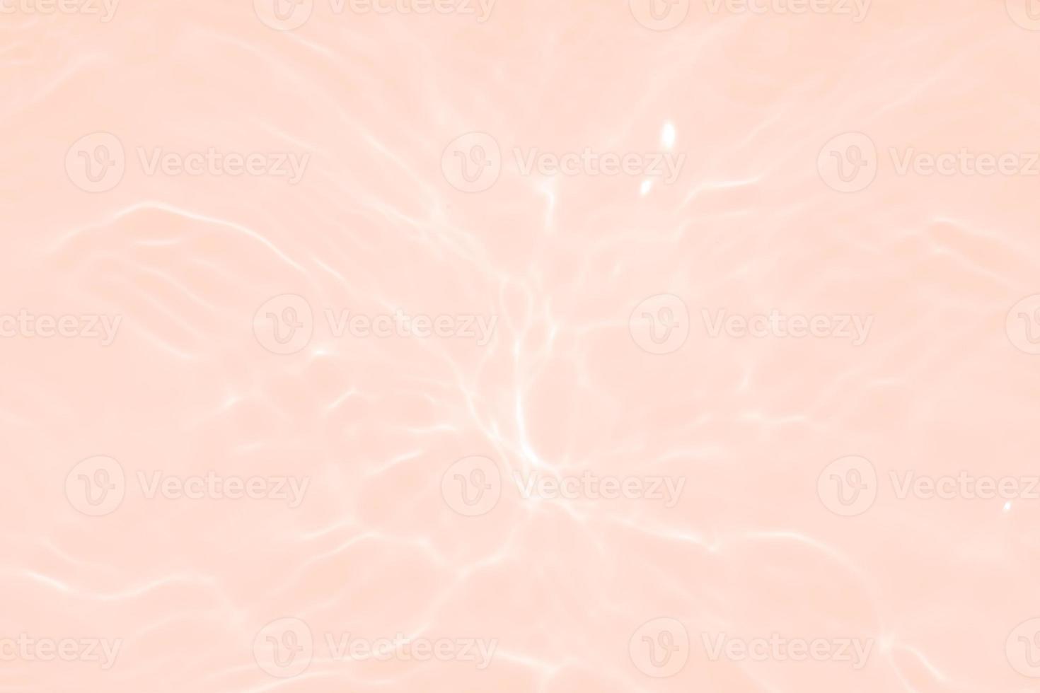 Defocus blurred transparent pink colored clear calm water surface texture with splash, bubble. Shining pink water ripple background. Surface of water in swimming pool. Tropical pink water textures. photo