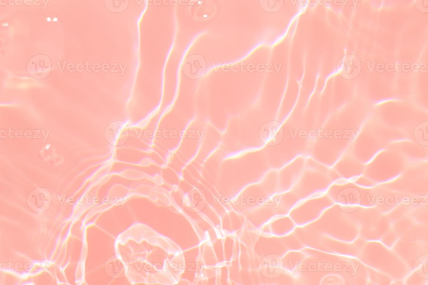 Defocus blurred transparent pink colored clear calm water surface texture with splash, bubble. Shining pink water ripple background. Surface of water in swimming pool. Tropical pink water textures. photo