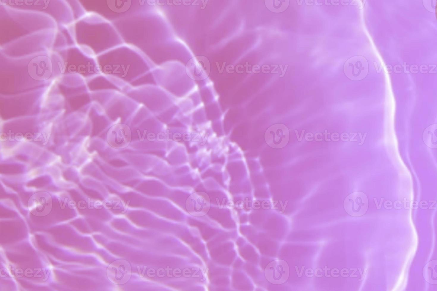 Defocus blurred transparent purple colored clear calm water surface texture with splash, bubble. Shining purple water ripple background. Surface of water in swimming pool. Tropical purple water color. photo