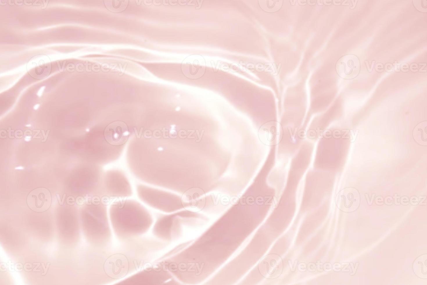 Defocus blurred transparent pink colored clear calm water surface texture with splash, bubble. Shining pink water ripple background. Surface of water in swimming pool. Tropical pink water textures. photo