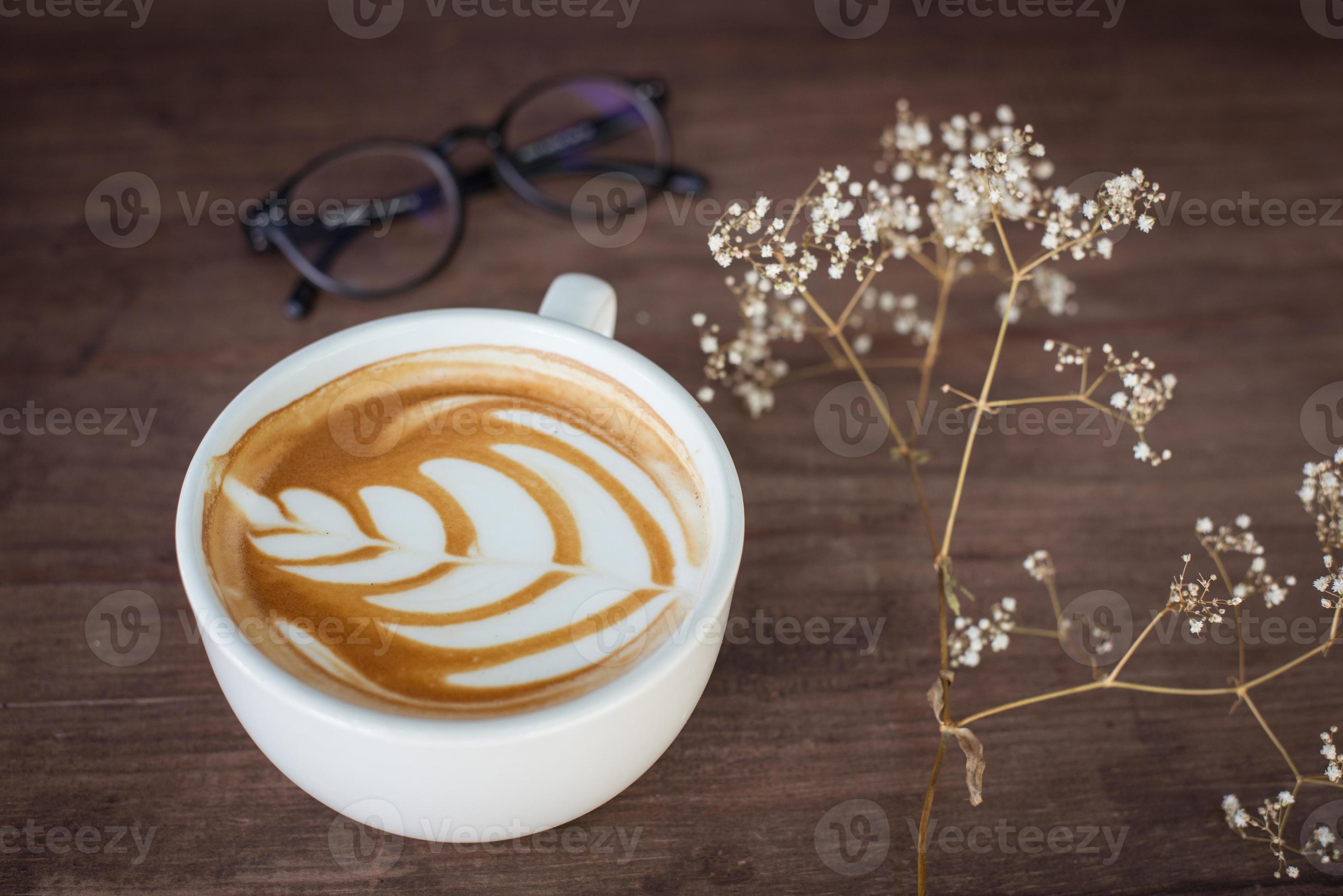 The mug of latte coffee with the latte art on the surface for the