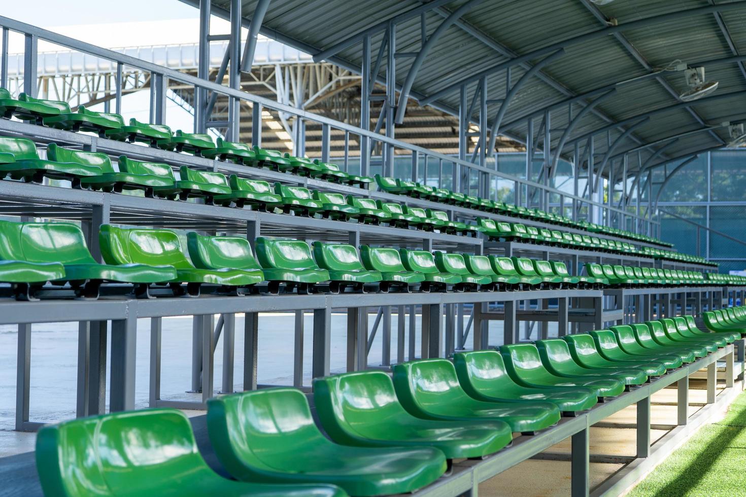 amphitheater for watching sports green,Plastic seats for watching outdoor sports such as football, tennis and basketball. photo