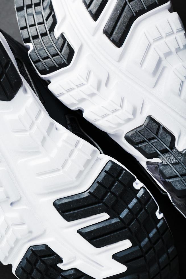 The black and white sole of trendy sports sneakers is a close-up in full screen. photo