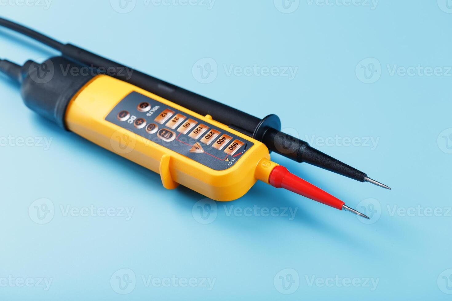 Yellow tester for step-by-step indication of voltage in an electrical circuit on a blue background. photo