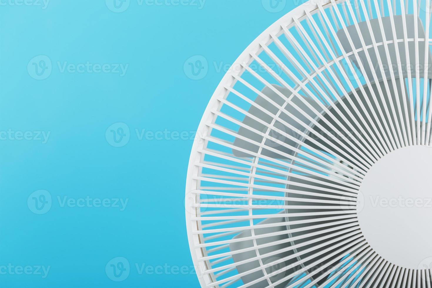 White modern electric fan for cooling the room on a blue background. photo