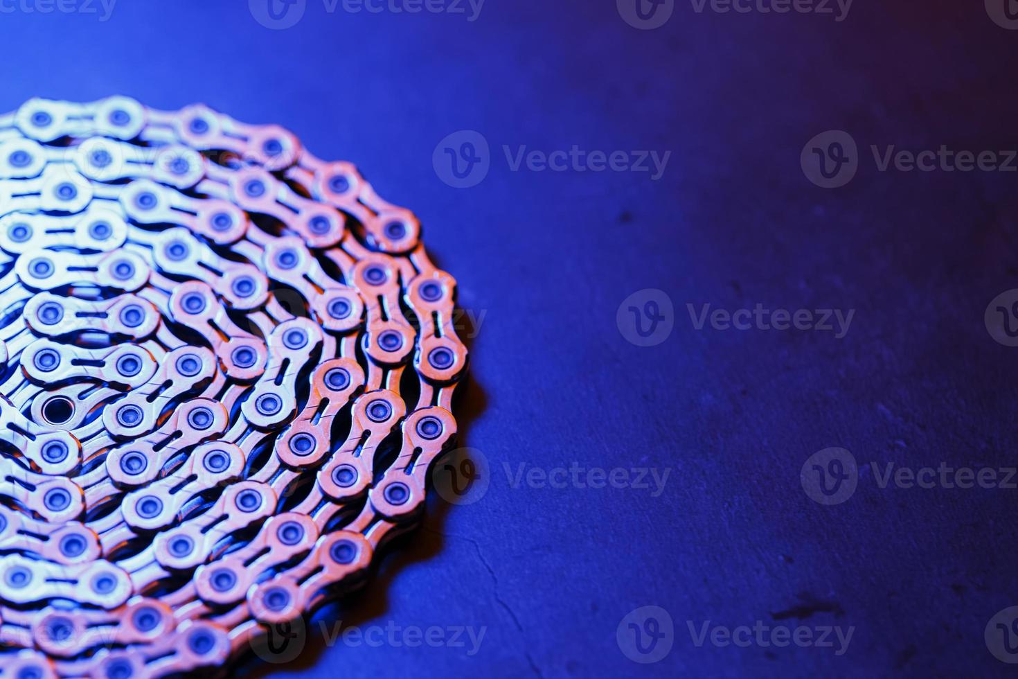 The texture of a Shiny bicycle chain with blue-purple backlight photo