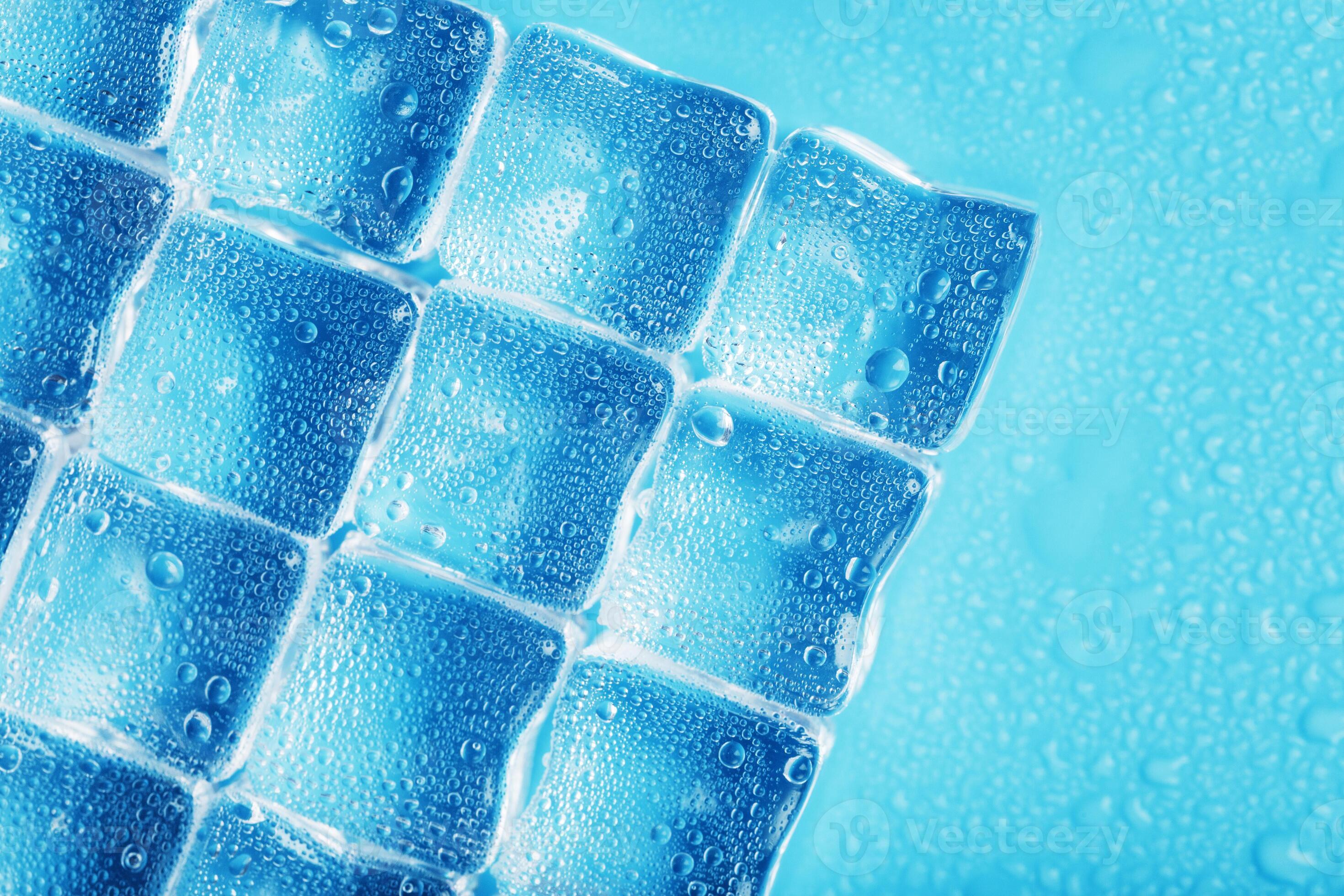 Ice made of cubes lined up with drops on a blue background 11078374