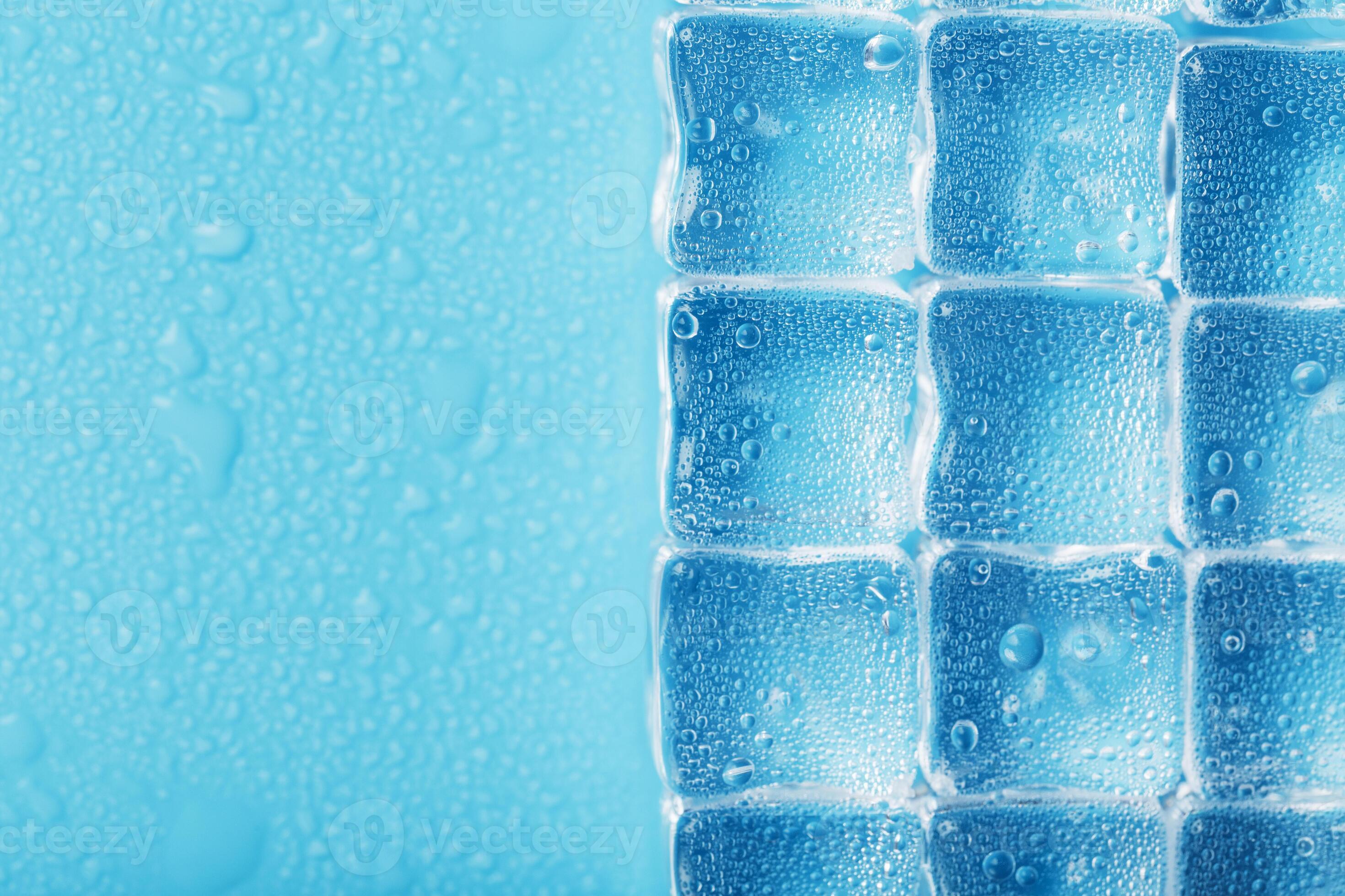 Ice made of cubes lined up with drops on a blue background 11078375
