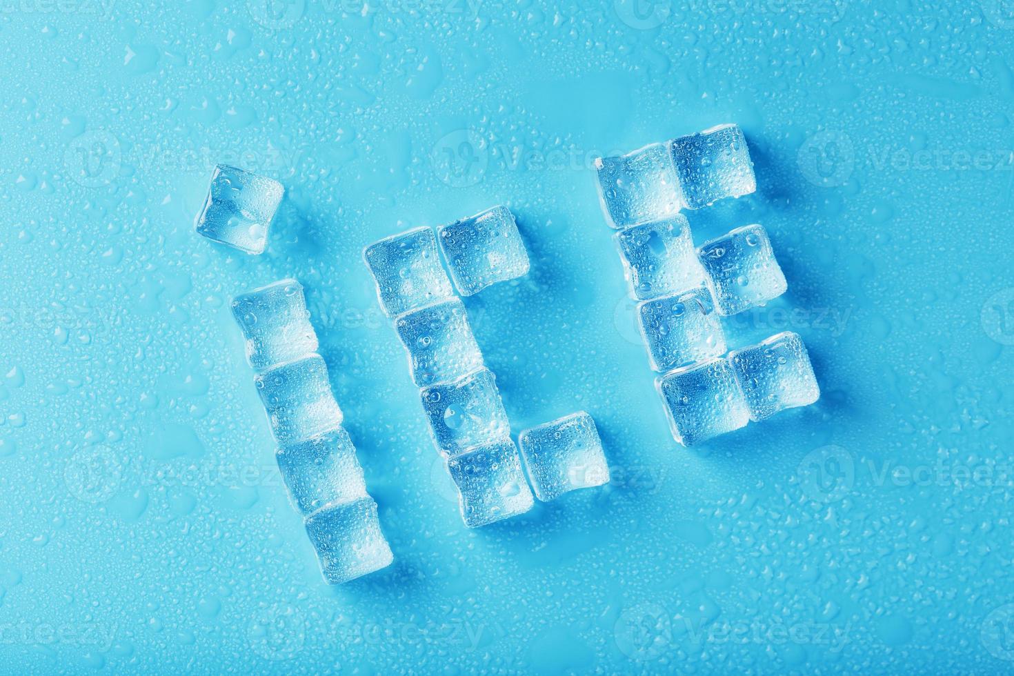 The word ICE is a pattern of ice cubes on a blue background photo