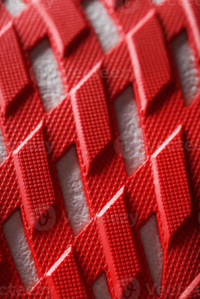 Running shoes with red soles on a black background. photo