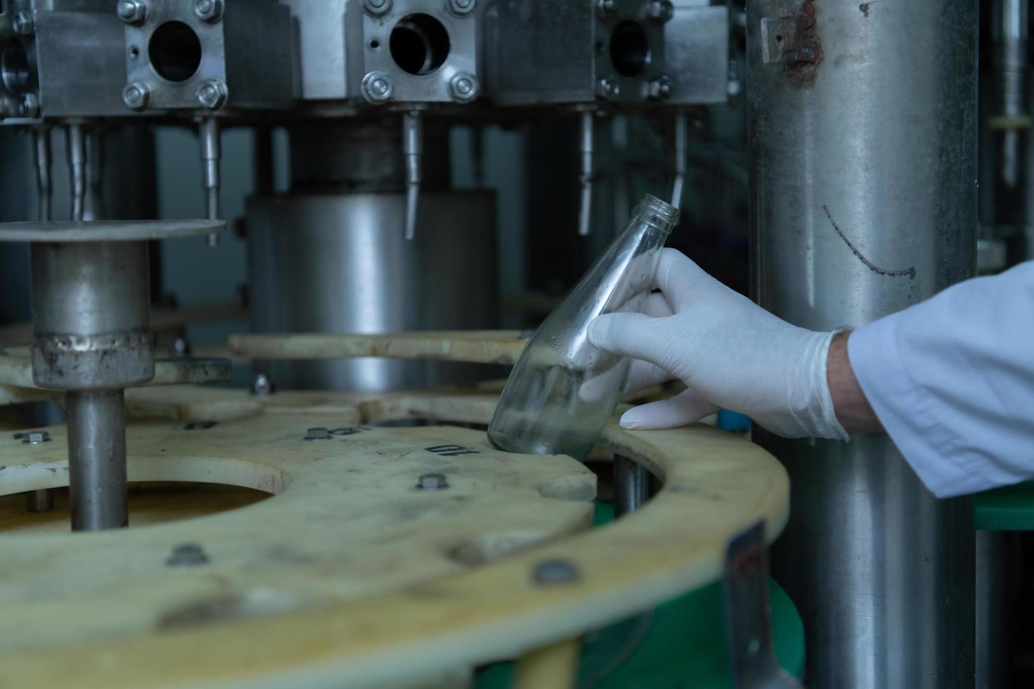 Product quality control officer in fruit juice production line Carry out an inspection of bottles used to contain fruit juices photo