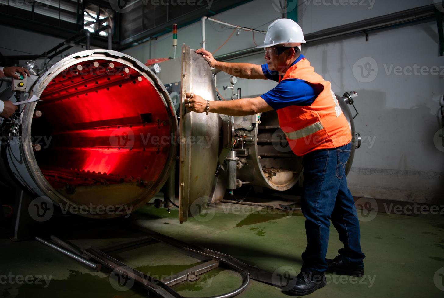 Engineer of the Mechanical Plant Conduct inspection of the sterilization machine tunnel. To check the working condition of the machine to be ready photo