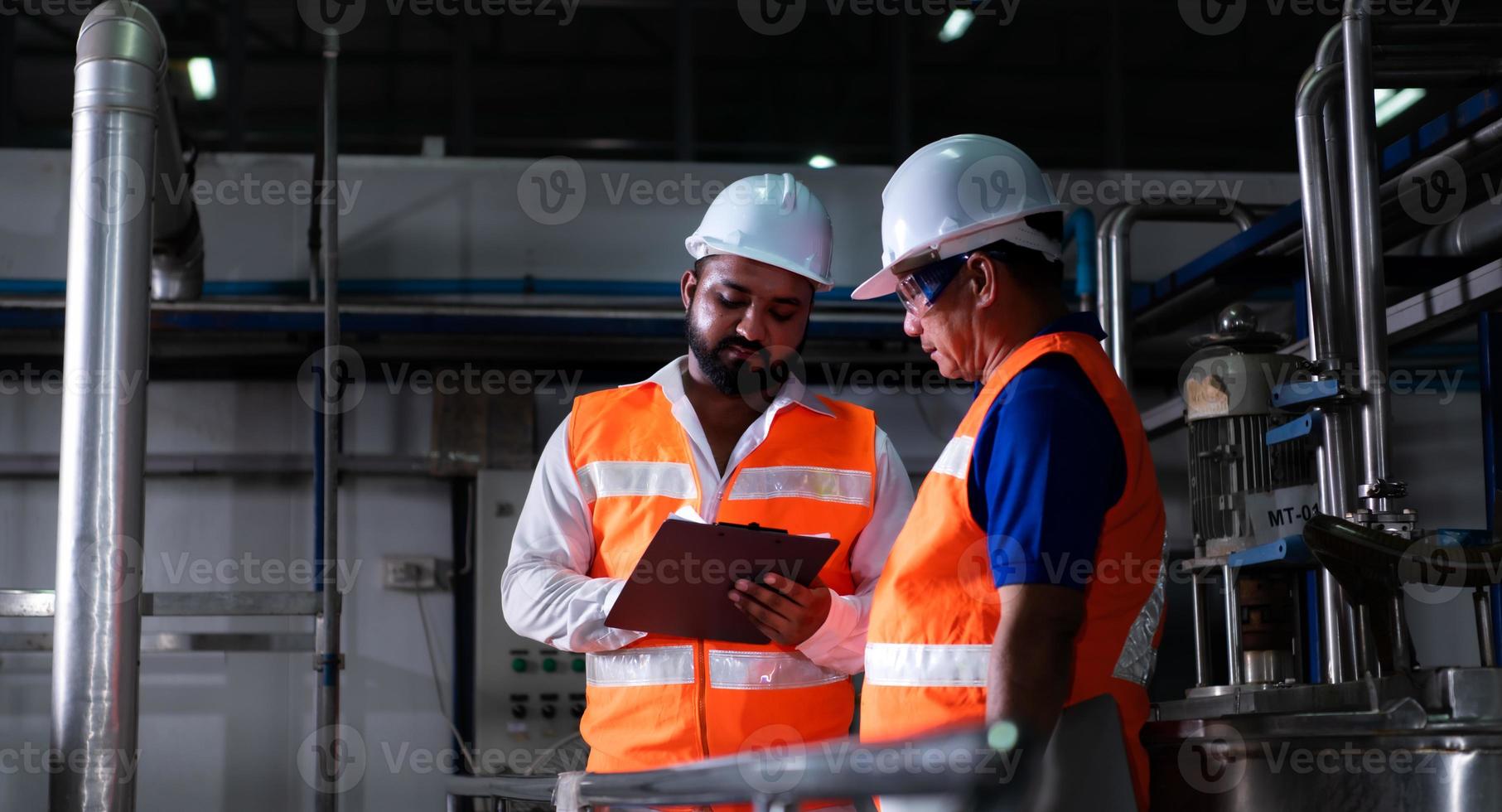 Chief engineer of a mechanical plant Inspecting and explaining the maintenance of the machine to the mechanic photo