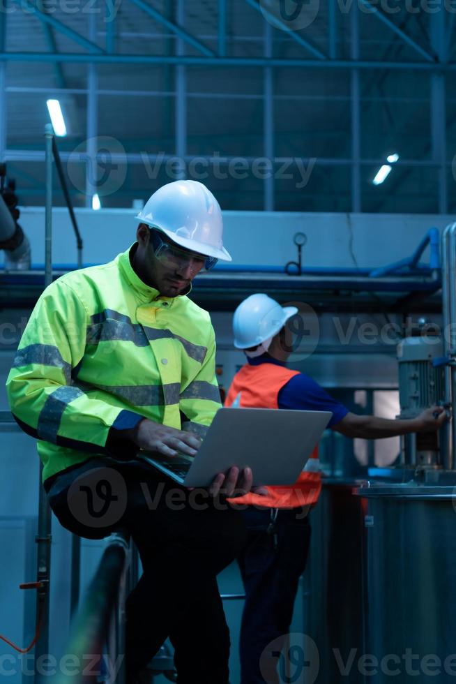 Chief Engineer of the Mechanical Plant Inspecting machine maintenance with factory technicians photo
