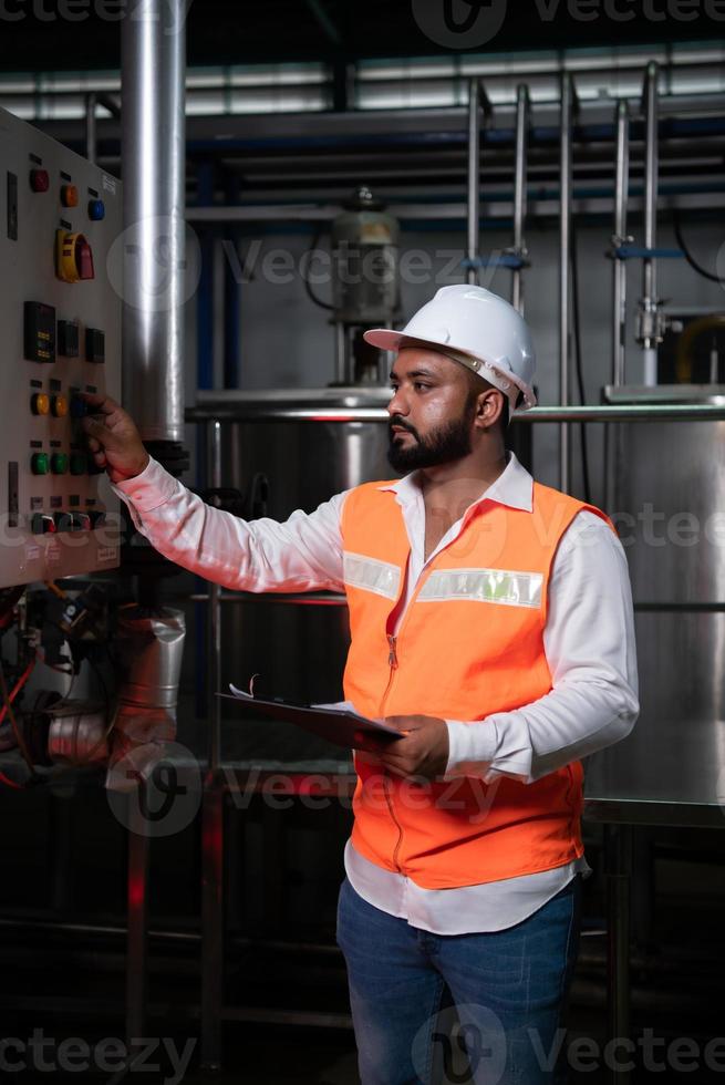 Engineer of Mechanical Plant Checking the electronic circuit of the machine to check readiness photo