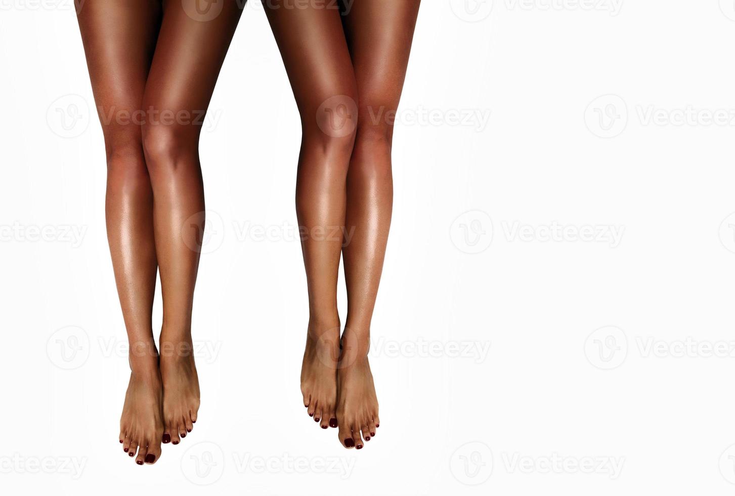 Beautiful smooth woman's legs after laser hair removal on the white background. Treatment, technology concept photo